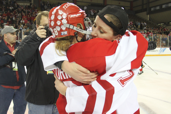 Ethan Magoc photo: Boston University and Wisconsin captains Holly Lorms (left) and Meghan Duggan embrace at center ice following the NCAA championship game on Sunday, March 20, 2011 at Tullio Arena.